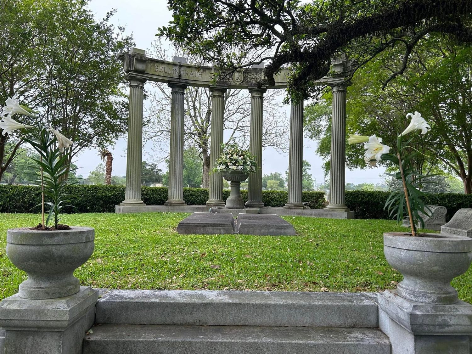 The columned Bellingrath memorial with a floral urn at its center, framed by live oaks