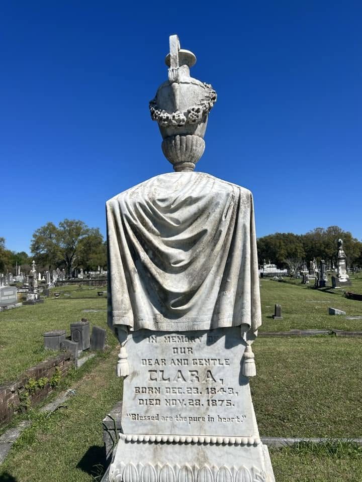 Draped marble urn crowning the monument to Clara, who died in 1875