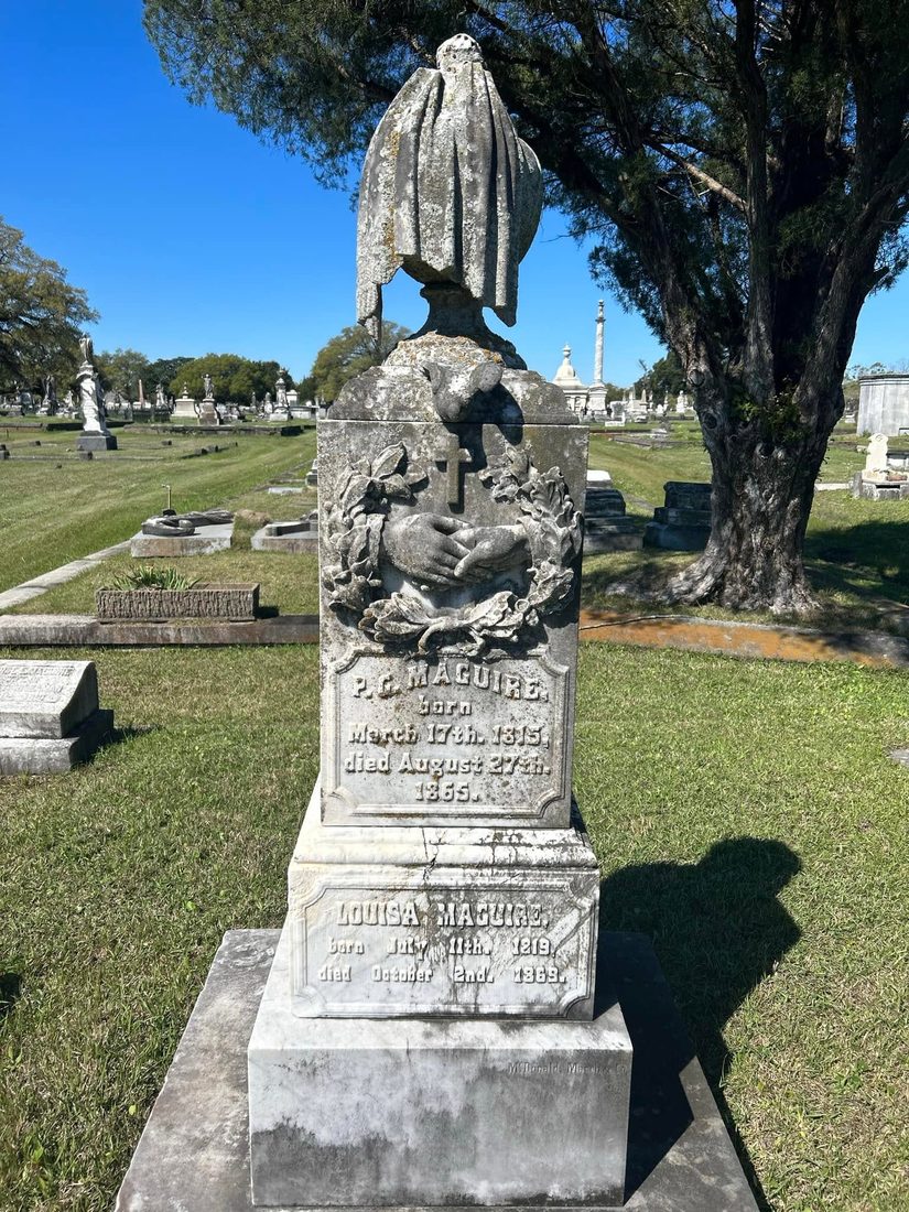 Clasped hands and a cross carved in a wreath on the Maguire monument, dated 1865